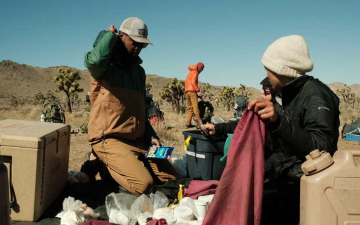 two people do camp tasks in Joshua Tree National Park
